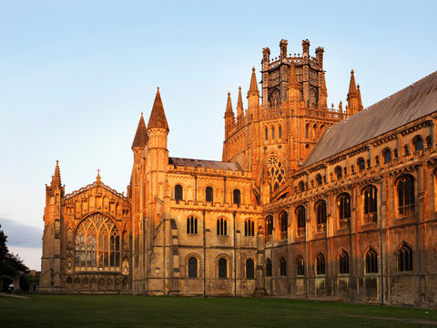 Sunset view of Ely Cathedral in Ely Cambridgeshire with changing light on the stone facade