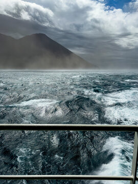 Gale force winds impact vessel in waters of Tanaga Bay near Aleutian Islands in Alaska during inclement weather conditions