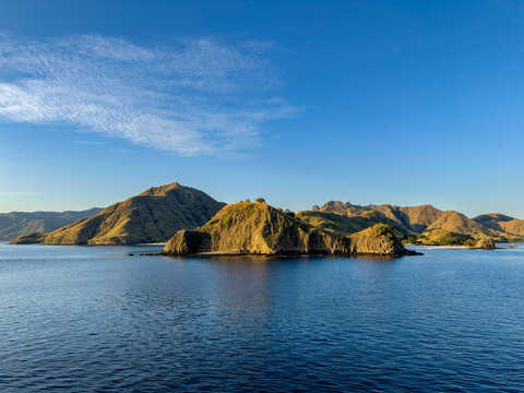 Views of Komodo Island with hills and water on a clear day in Indonesia near West Manggarai Regency