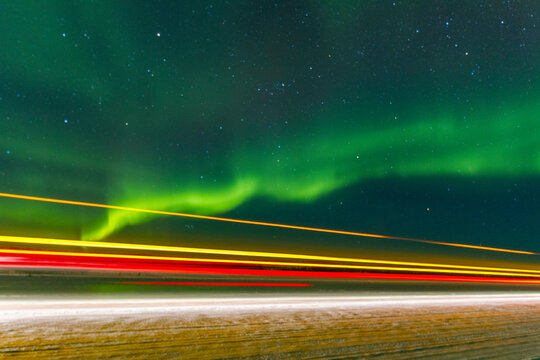 Long exposure captures Jeep lights and aurora borealis over Great Slave Lake in Northwest Territories Canada