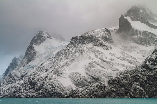 Views of snowstorm in Larsen Harbour with mountains and sea in Drygalski Fjord on South Georgia Island