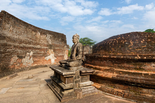 Vatadage circular temple in Polonnaruwa shows ancient architecture and a seated Buddha statue from 12th century Sri Lanka