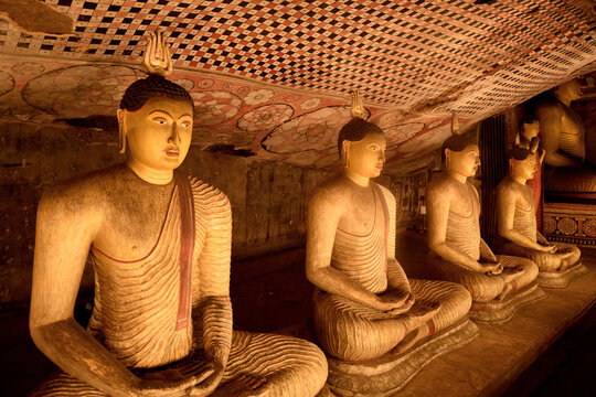 Buddha statues and murals display in Dambulla Cave Temple showcasing ancient Sri Lankan art and culture