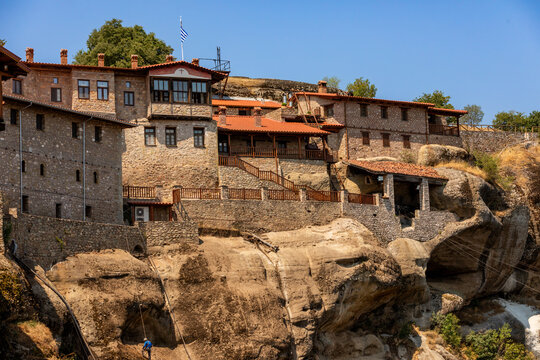 Holy Monastery of Varlaam built on rock formations with stone structures overlooking the valley in Meteora, Greece