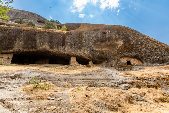 View of rock-cut entrances in the Hermit Caves used by monks for seclusion and meditation in Meteora, Thessaly, Greece