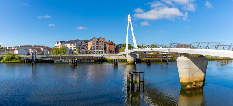 Govan-Partick Bridge spans River Clyde connecting areas of Glasgow in Scotland with clear blue skies above