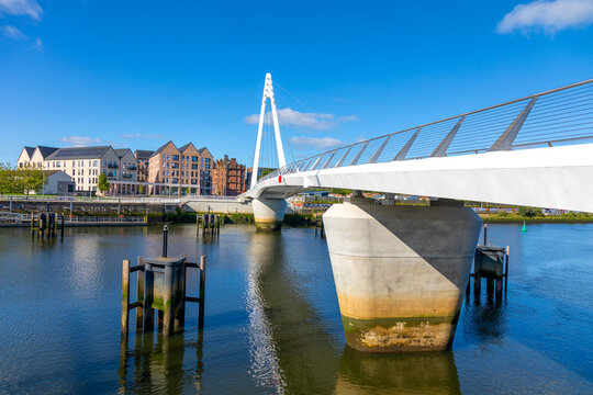 Govan-Partick Bridge spans River Clyde in Glasgow, showcasing modern design and urban landscape