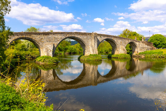Stirling Bridge over River Forth with reflections and green surroundings in Scotland