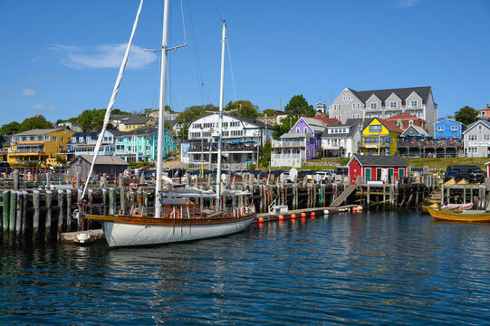 Colorful buildings surround boats at Lunenburg Harbourfront on a sunny day