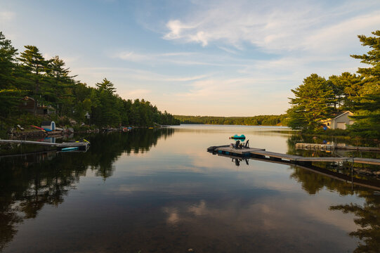 View of Millet Lake during sunset with boats and reflections seen in the calm water in Chester Nova Scotia
