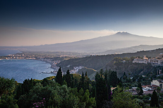View of Mount Etna from ancient theater in Taormina during early evening light