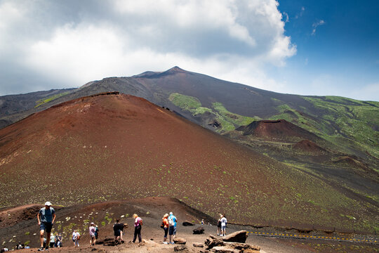 Hiker trekking on the slopes of Mount Etna in Catania, Italy, enjoying the landscape and nature