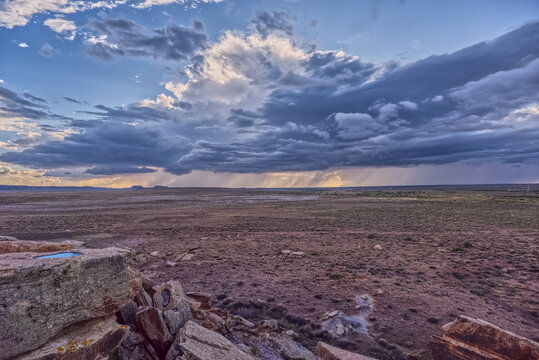 Storm clouds gather over the vast landscape of Petrified Forest National Park Arizona from Newspaper Rock Overlook