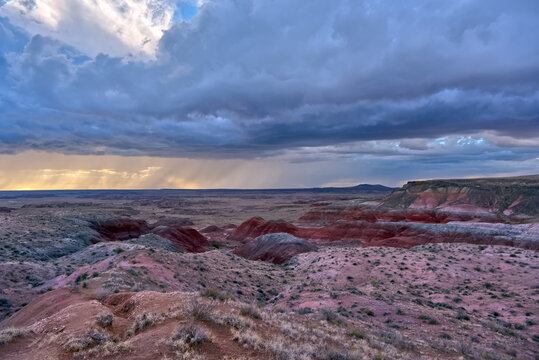 Storm clouds gather over the landscape at Whipple Point in Petrified Forest National Park, creating a dramatic scene
