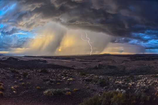 Storm with lightning approaches Pintado Point at Petrified Forest National Park near sunset in Arizona