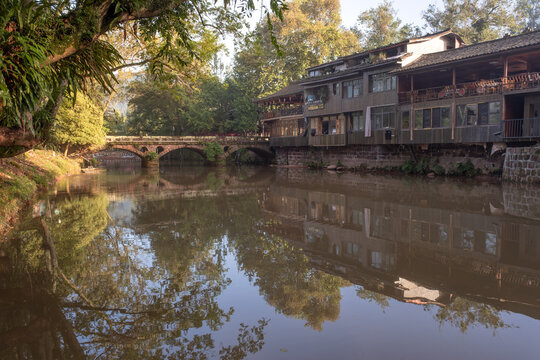 Three arched stone bridge with reflections in river at dawn in Shangli Town, Sichuan, China
