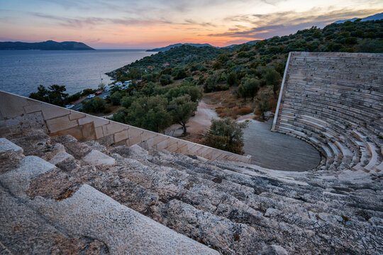 Sunset view of the ancient theater in Antiphellos with the coastline in the background in Kas, Turkey