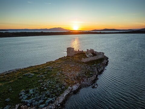 Drone view captures Kizlar monastery on an island during sunset in Turkey, showcasing nature and architecture