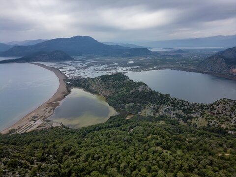 Drone view reveals cloudy skies over Dalyan turtle bay and its surrounding landscape in Turkey