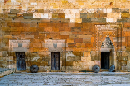 Beautiful wooden doors with stone frame adornments in Saruhan Caravanserai in Cappadocia, Turkey showcasing medieval architecture