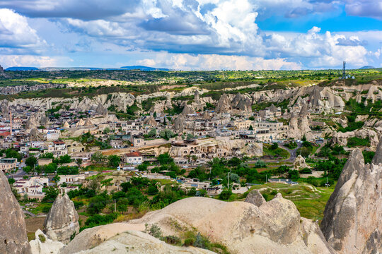 Goreme town in Cappadocia Turkey with Rocket Valley rock formations in the background during daytime