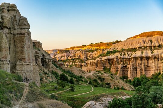 Sunset casts light on Pigeon Valley rock formations in Cappadocia Turkey showcasing the unique landscape of the region