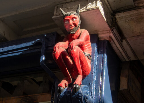 Carving of the Stonegate Devil located above entrance of historic building in York from the 17th century