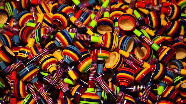 HD 1080p video at 60 fps. of a bunch of colorful traditional Mexican toys called cup-and-ball toys.

