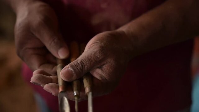 HD 1080p video at 60 fps of a craftsman showing his gouges in his hands for wood carving
