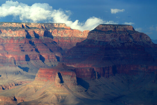 Views of Grand Canyon from South Rim show rock formations and cloud coverage in Arizona landscape during daylight hours