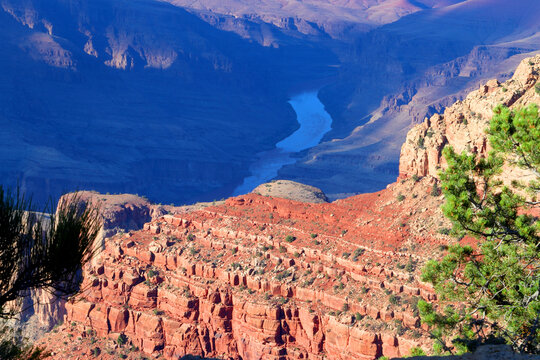 Views of the Colorado River winding through the Grand Canyon landscape, showing layers of rock formations and varied terrain in Arizona