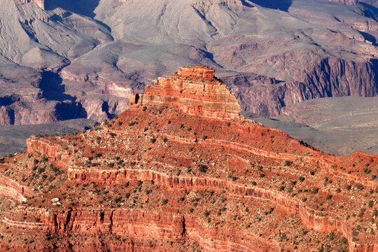 View of rock formations in Grand Canyon from South Rim, Arizona, USA showing layers of red stones and distant cliffs