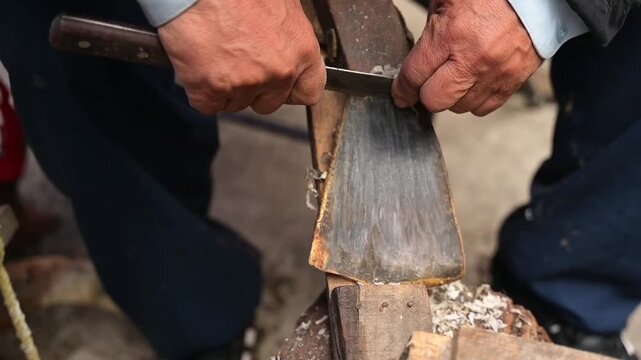 HD 1080p video at 60 fps of an artisan scraping horn to make crafts.
