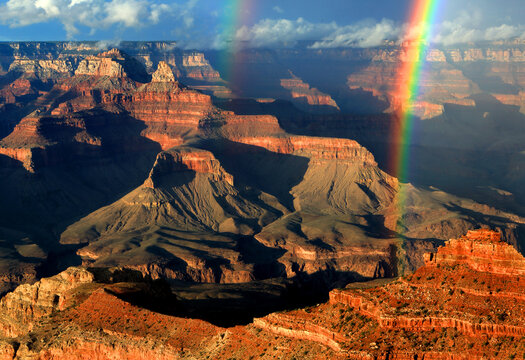 View of Grand Canyon with rainbow over rock formations from the South Rim in Arizona USA