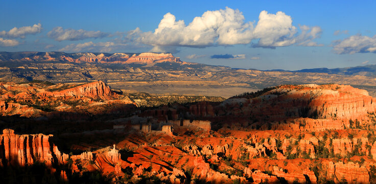 Sunset view of Bryce Canyon showing rock formations and distant mountains in Utah