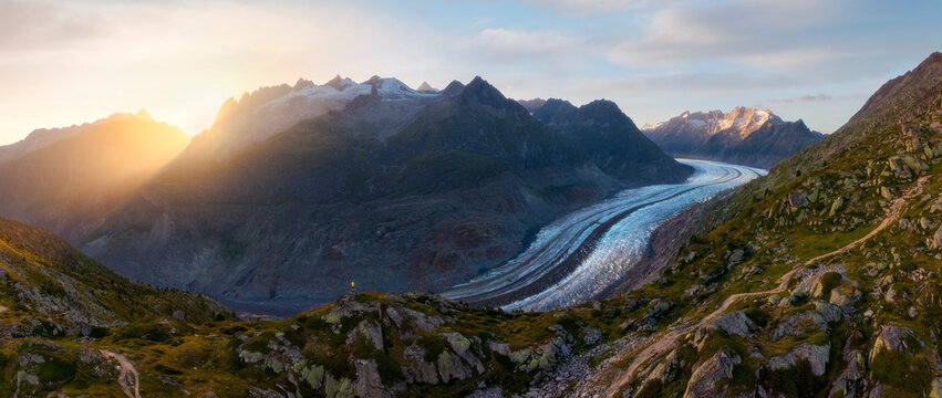 View of trekker at Aletsch Glacier during sunset in summer in Riederalp, Oriental Raron, Valais, Switzerland