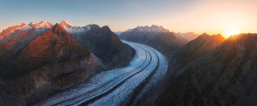Aletsch Glacier stretches majestically as sunlight breaks over the peaks in summer from Riederalp, Valais