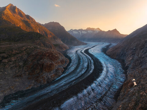 Sunrise over Aletsch Glacier shows the winding ice formation in summer light near Riederalp, Valais, Switzerland