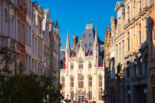 Sunset view of Provinciaal Hof in Bruges with nearby buildings and street scene in East Flanders, Belgium