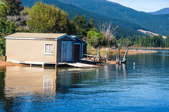 Wooden boathouse on the shoreline of Marlborough Sounds in South Island, New Zealand during sunny weather