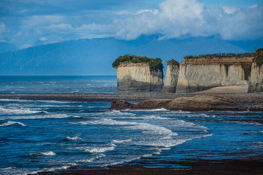 Explore stunning white cliffs along the rugged Tasman Sea coast near Cape Foulwind in New Zealand with dramatic limestone formations and waves