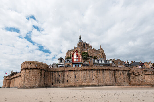Historic stone ramparts and medieval houses stand tall in Mont Saint-Michel, showcasing architecture and history in Normandy, France