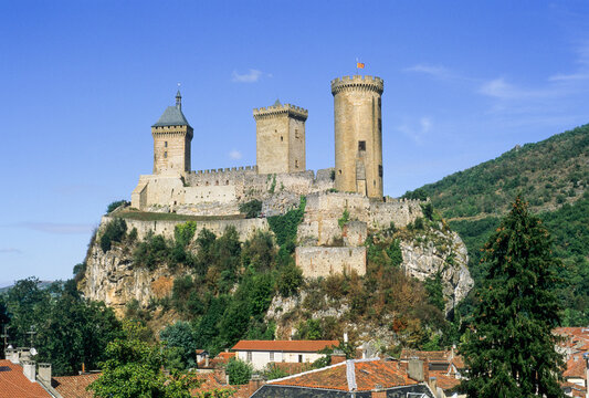Historic castle rises over the city of Foix in Ariege, showcasing its medieval architecture and scenic surroundings in southern France