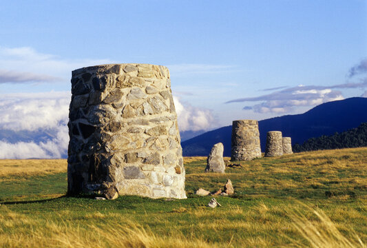Cairns at Pailheres Pass in Donezan region, a view of stone markers on grassy terrain in France