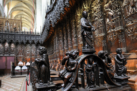 Wooden choir stalls feature detailed carvings inside the Cathedral in Auch, Gers department of France