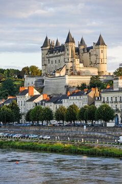 View of Chateau de Saumur along the banks of the Loire River in Maine-et-Loire department in France during daylight hours