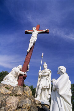 Cross and figures at Way of the Cross in Ponchateau gathered under a clear sky in Loire-Atlantique department of France
