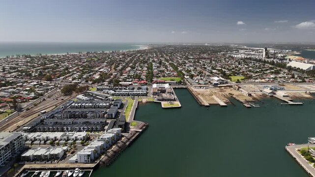 Port Adelaide, South Australia: 4K aerial drone footage of harbour, Port River, marina, coastal suburbs and historic waterfront cityscape, presidential houses, estates in Semaphore, Birkenhead. 