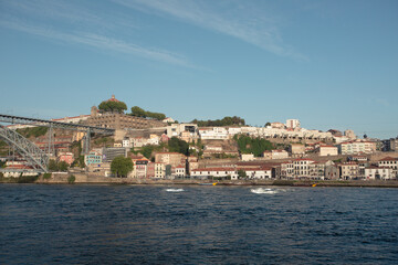 Fototapeta premium The river in Porto, Portugal, a view from above of the city and the river with passing ships at dawn