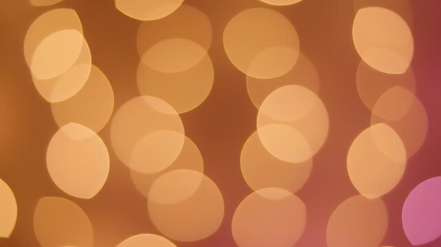 A vibrant abstract composition features softly focused, circular highlights in warm orange, transitioning to a pinkish hue in the corner